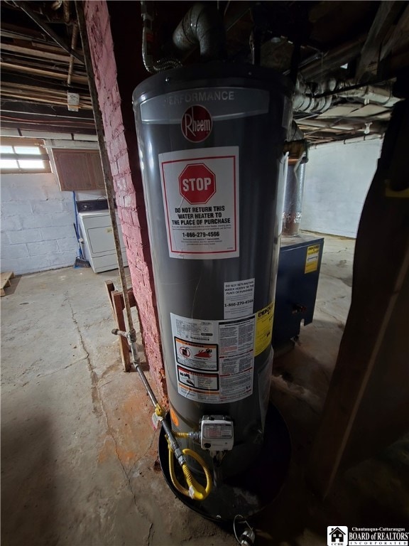 utility room featuring washer / dryer and water heater