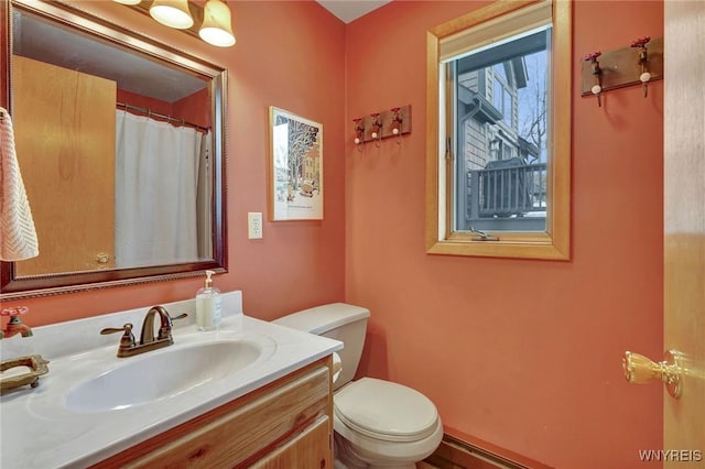 full bathroom with vanity and toilet