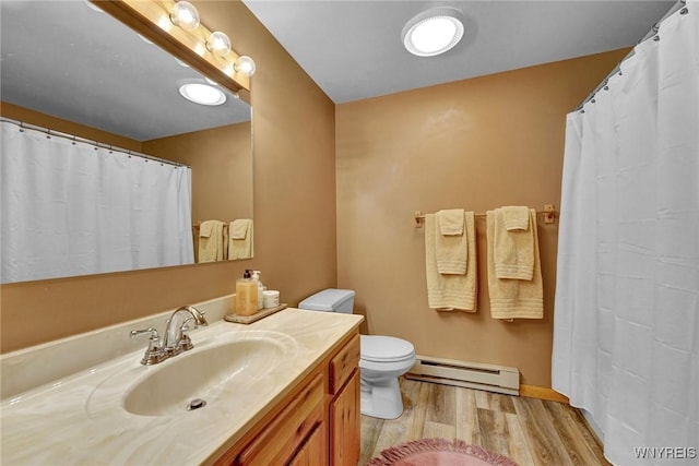 full bathroom with vanity, a baseboard radiator, wood finished floors, and toilet