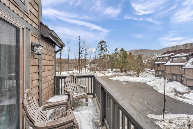 view of snow covered back of property