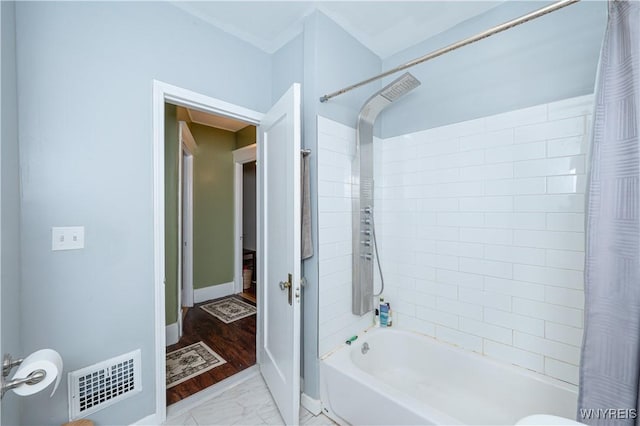 full bath with marble finish floor, baseboards, shower / bath combo, and visible vents