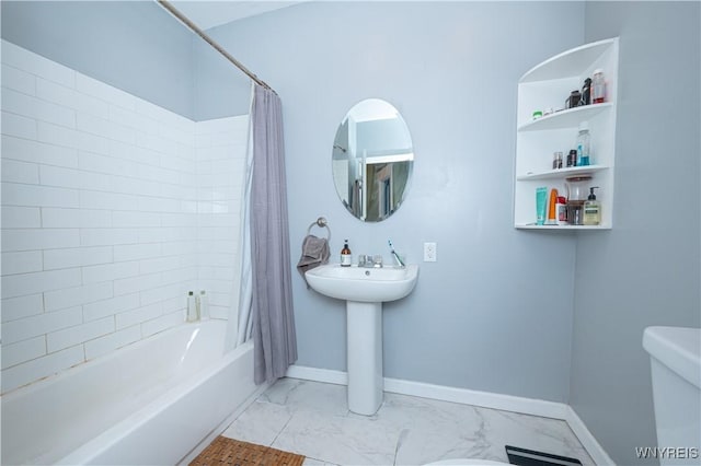 bathroom with marble finish floor, toilet, shower / bathtub combination with curtain, and baseboards