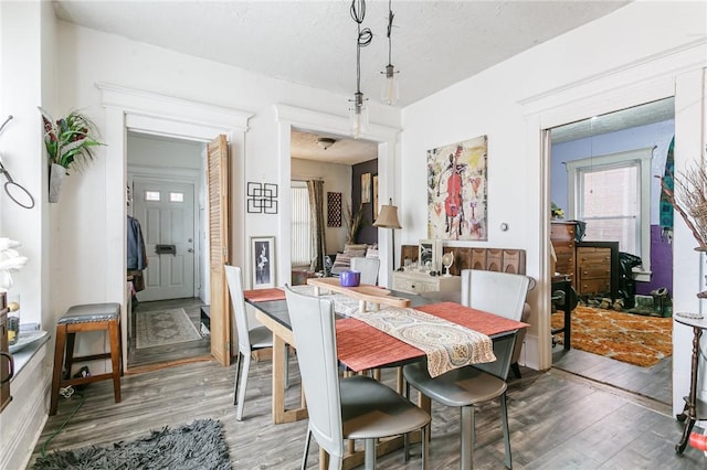 dining area with wood finished floors