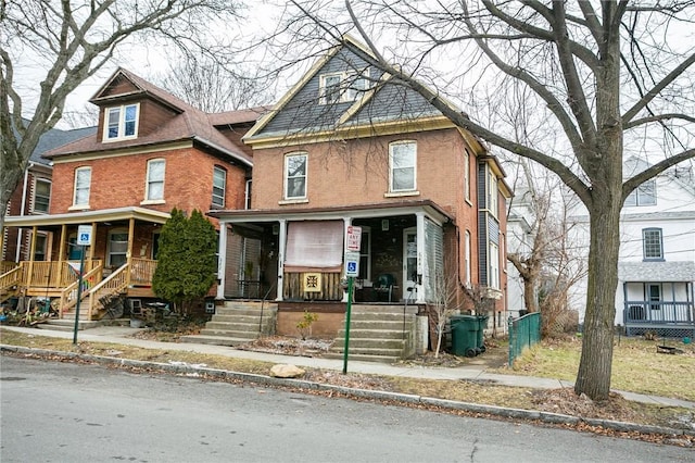 view of front facade with a porch and brick siding