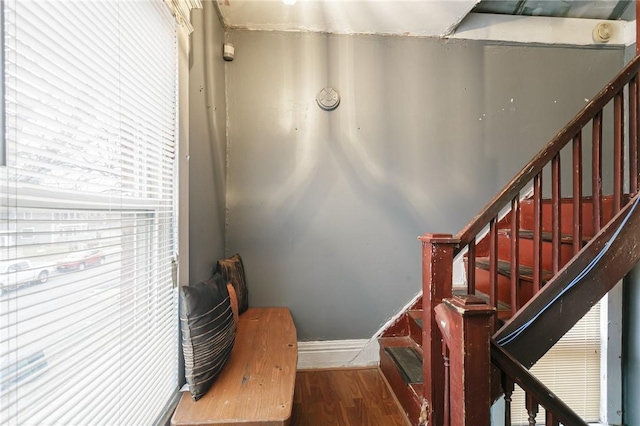 stairway with baseboards and wood finished floors