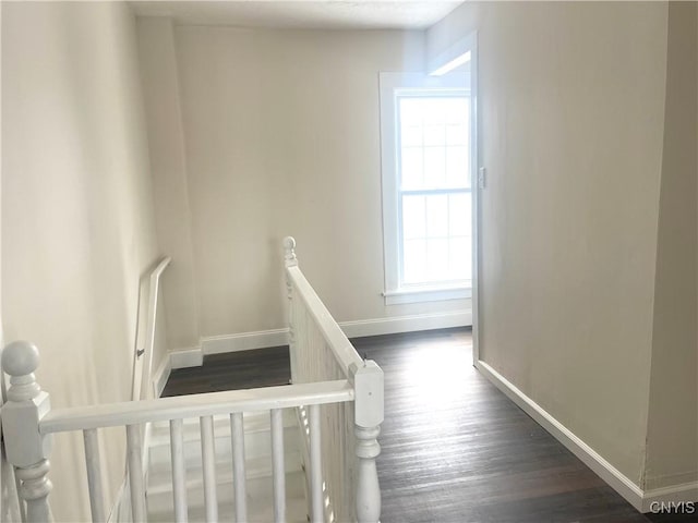 stairway featuring baseboards and wood finished floors