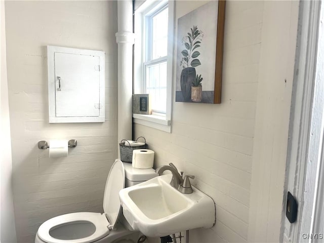 half bath with a sink and toilet