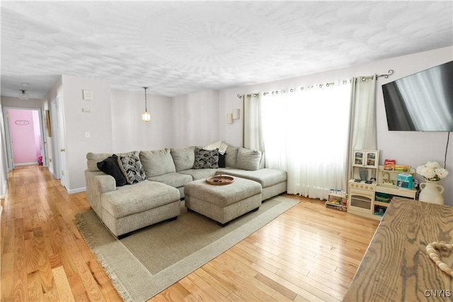 living room featuring light wood-style flooring and baseboards