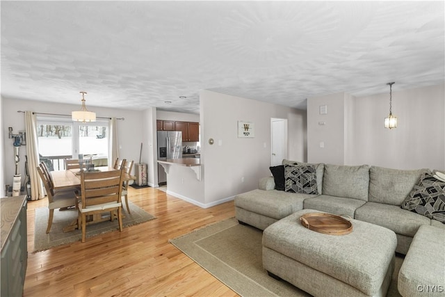 living room featuring light wood finished floors and baseboards