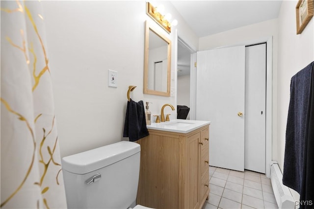 bathroom featuring toilet, vanity, baseboard heating, and tile patterned floors