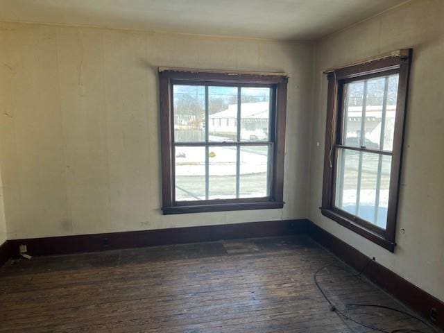 empty room featuring hardwood / wood-style floors and baseboards