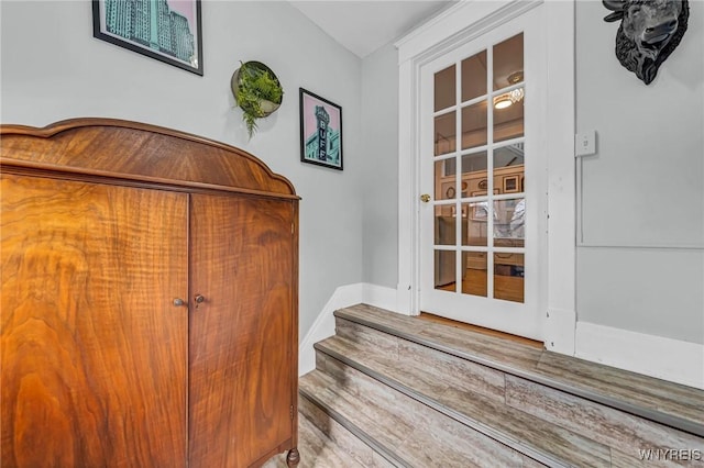 doorway to outside featuring baseboards