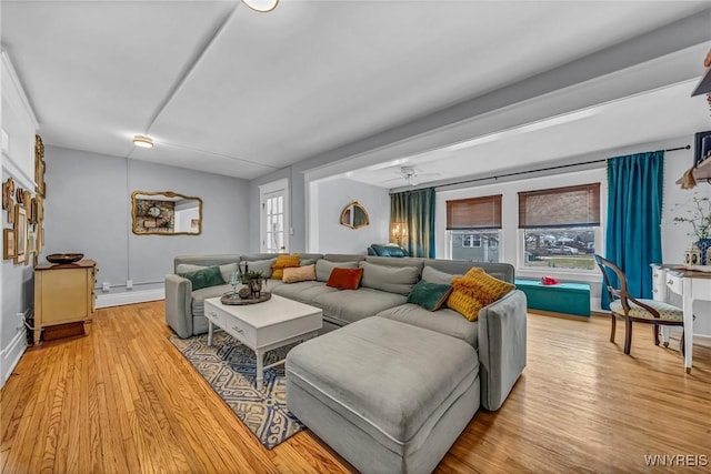 living area featuring light wood-style floors and ceiling fan