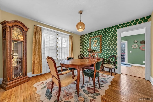 dining area featuring baseboards and wood finished floors