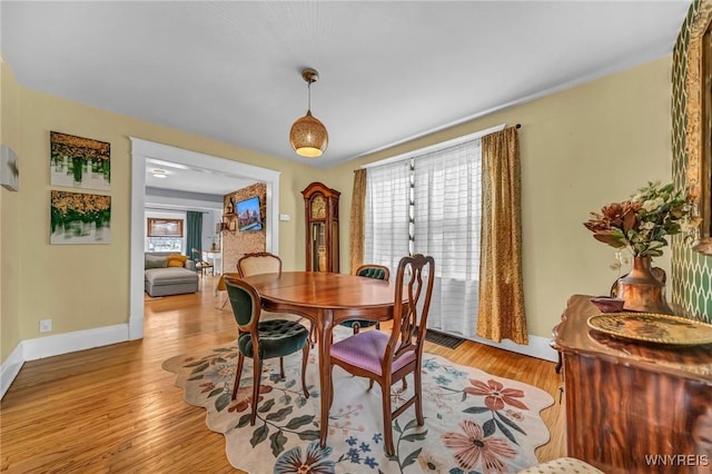 dining room with light wood finished floors and baseboards