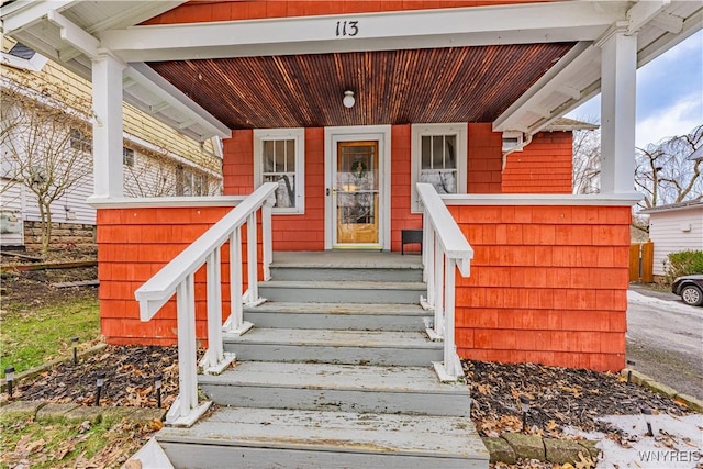 entrance to property featuring a porch