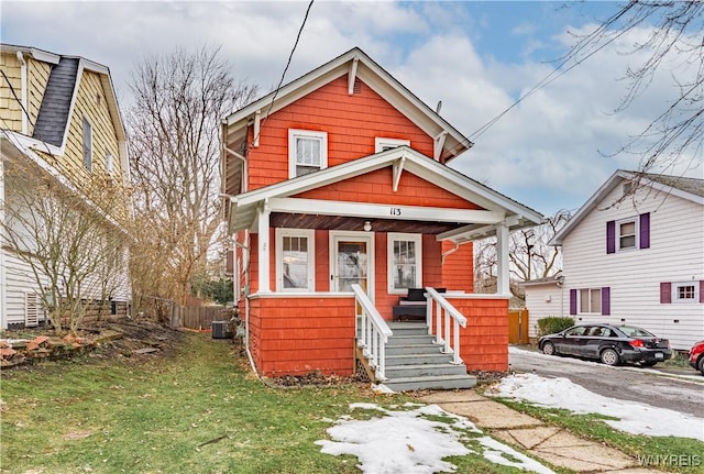 view of front of home featuring a porch and fence