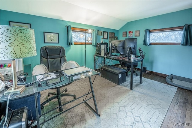 office featuring vaulted ceiling, baseboards, and wood finished floors