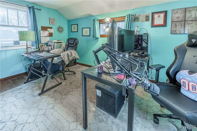 home office with lofted ceiling, baseboards, and wood finished floors