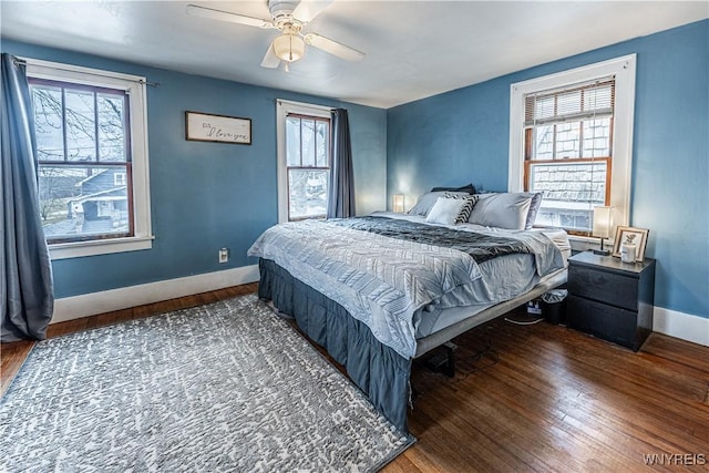 bedroom featuring ceiling fan, baseboards, and hardwood / wood-style flooring