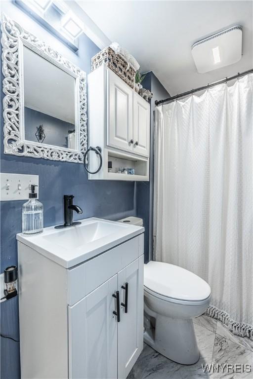 full bathroom with marble finish floor, vanity, and toilet