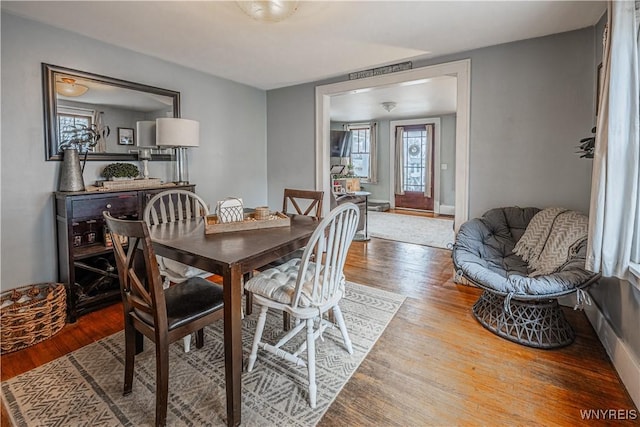 dining space featuring wood finished floors, visible vents, and baseboards