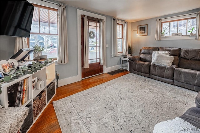 living area featuring baseboards and wood finished floors