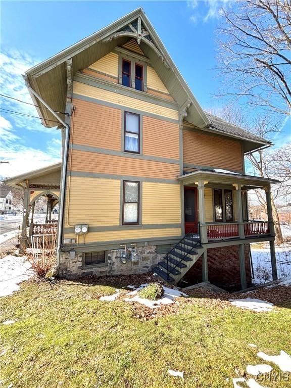 view of front of house featuring stairway and a porch