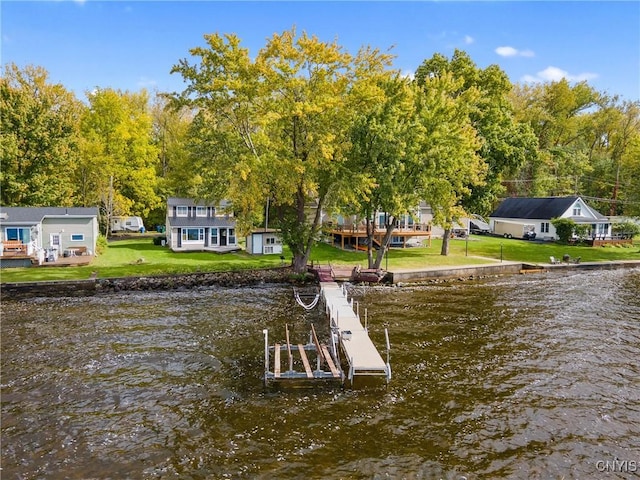 dock area with a water view and a lawn