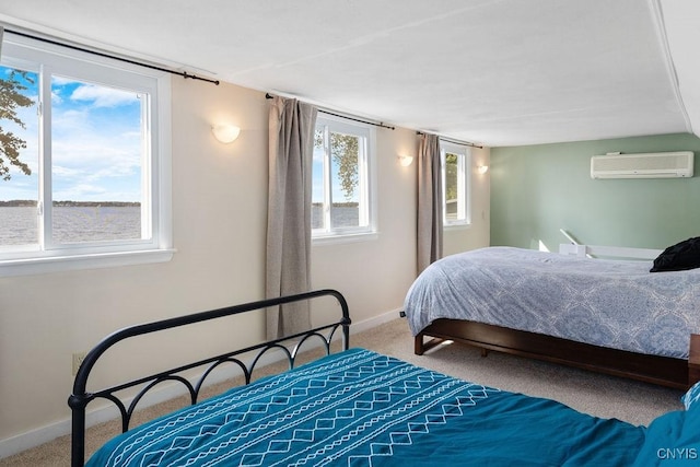 bedroom featuring an AC wall unit, carpet flooring, and baseboards