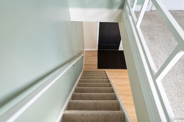 staircase with wood finished floors