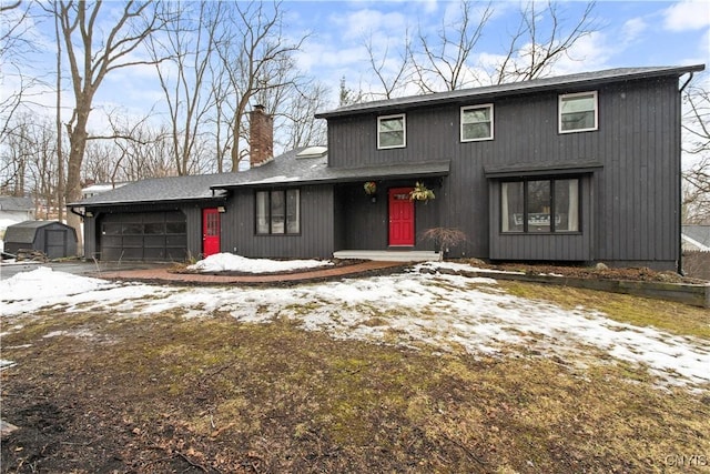 view of front of house with an attached garage and a chimney