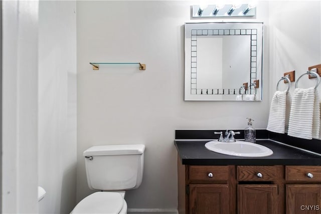 half bathroom featuring toilet and vanity