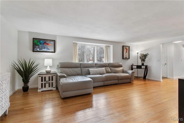 living room featuring light wood-type flooring and baseboards