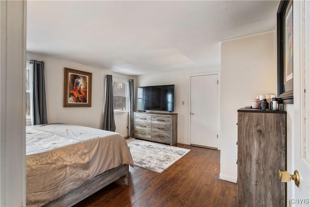 bedroom with wood finished floors and baseboards