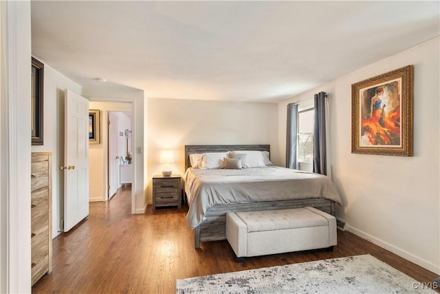 bedroom featuring baseboards and wood finished floors