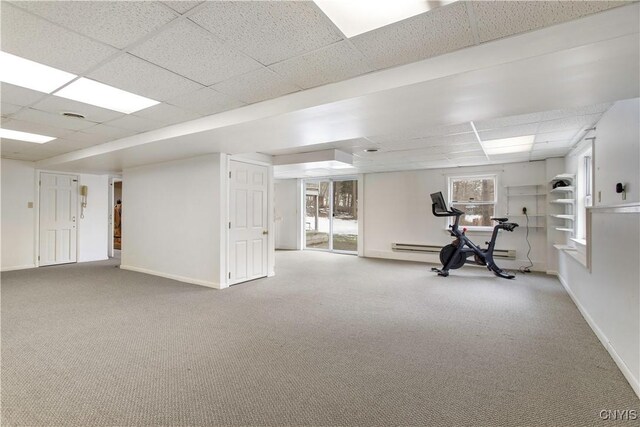 workout room with carpet floors, a paneled ceiling, and baseboards