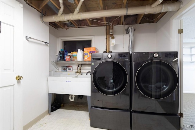 laundry room featuring laundry area, separate washer and dryer, and tile patterned floors