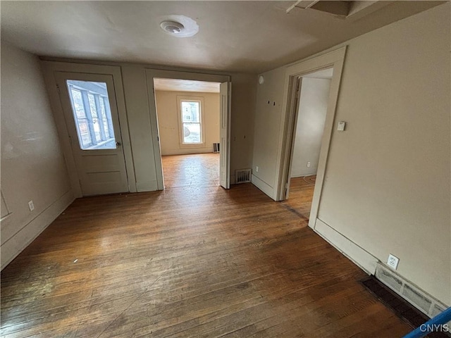 entryway with dark wood finished floors and visible vents