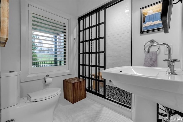 bathroom with tile patterned flooring, a sink, and toilet