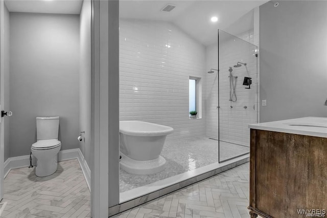 full bathroom featuring visible vents, toilet, a walk in shower, a freestanding tub, and baseboards