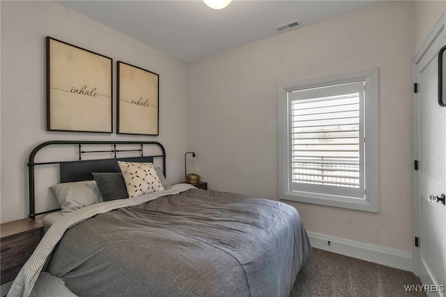 carpeted bedroom with baseboards and visible vents