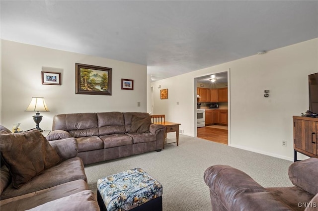 living room featuring light carpet and baseboards