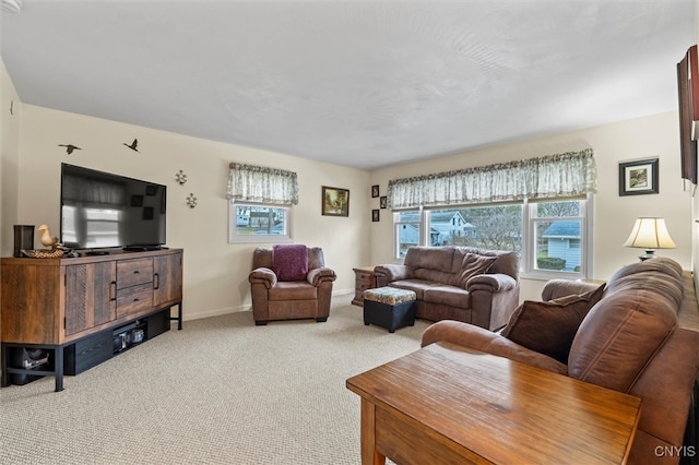 carpeted living room with baseboards and a healthy amount of sunlight