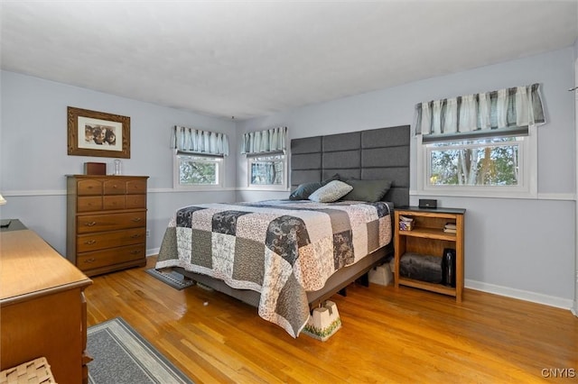 bedroom featuring wood finished floors and baseboards