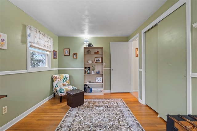 sitting room featuring baseboards and wood finished floors