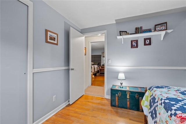 bedroom featuring baseboards and wood finished floors