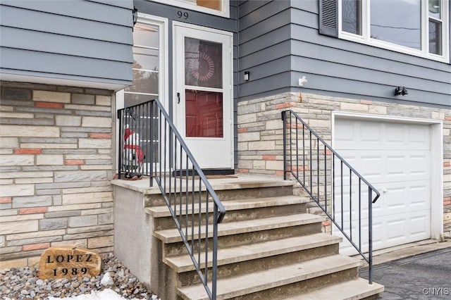 doorway to property with an attached garage