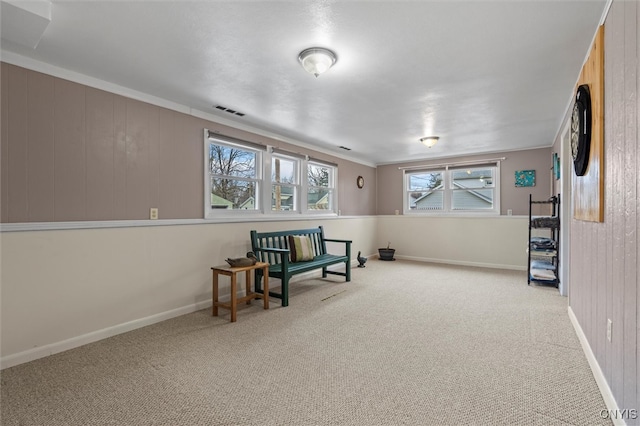 sitting room with carpet flooring, visible vents, and baseboards