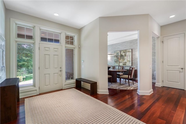 foyer featuring dark wood-type flooring, recessed lighting, and baseboards